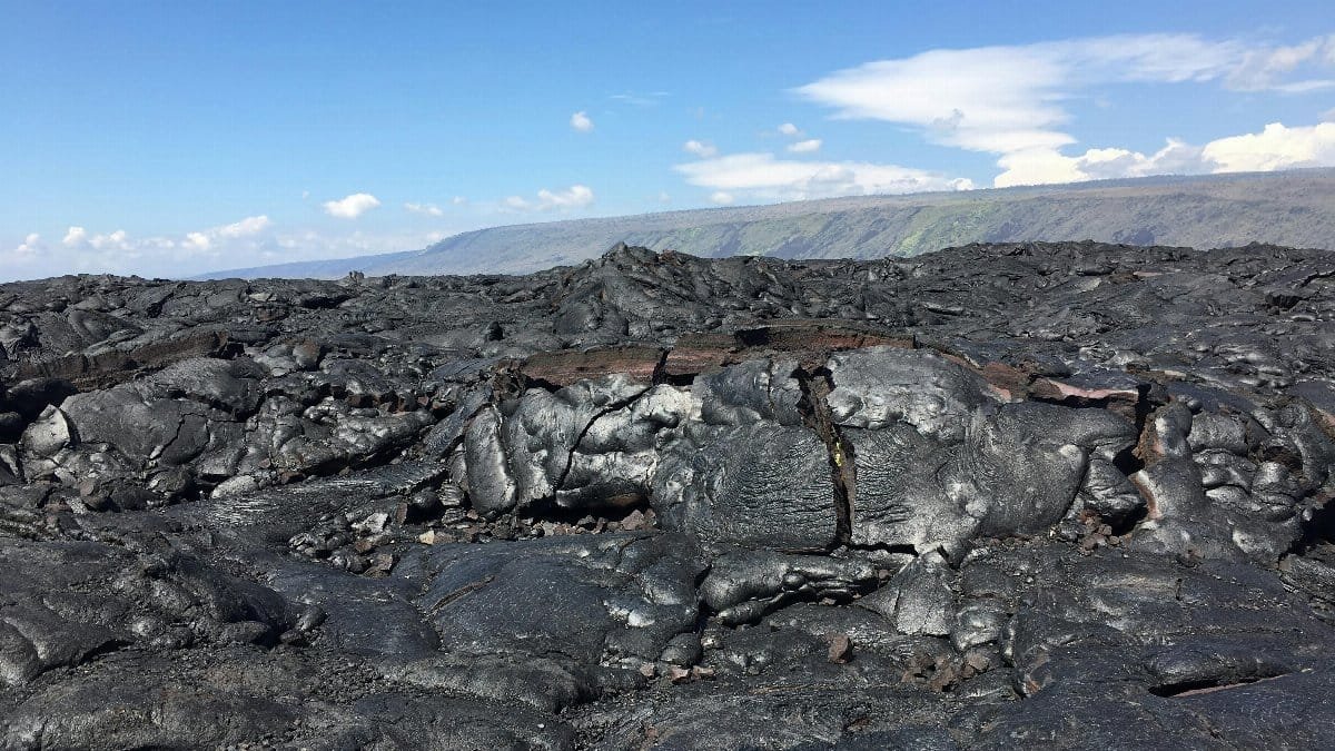 A broad view of solidified lava rocks under a clear sky in Volcano, Hawaii. via Pexels