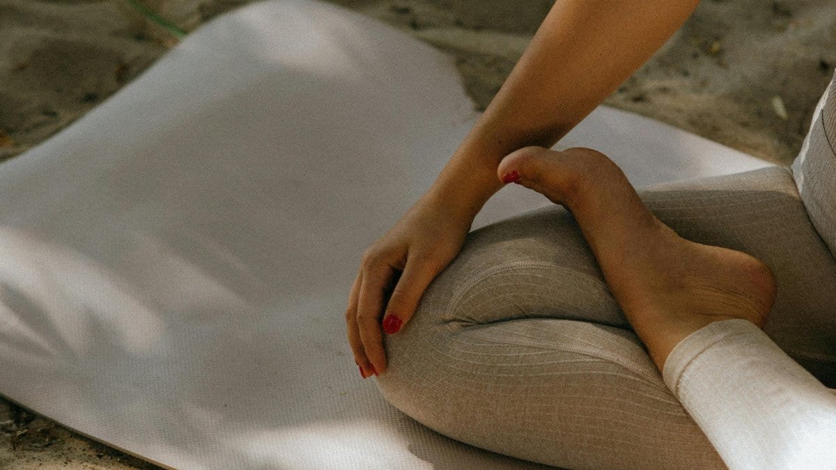 Peaceful yoga practice on sandy beach, embodying relaxation and mindfulness. via Pexels