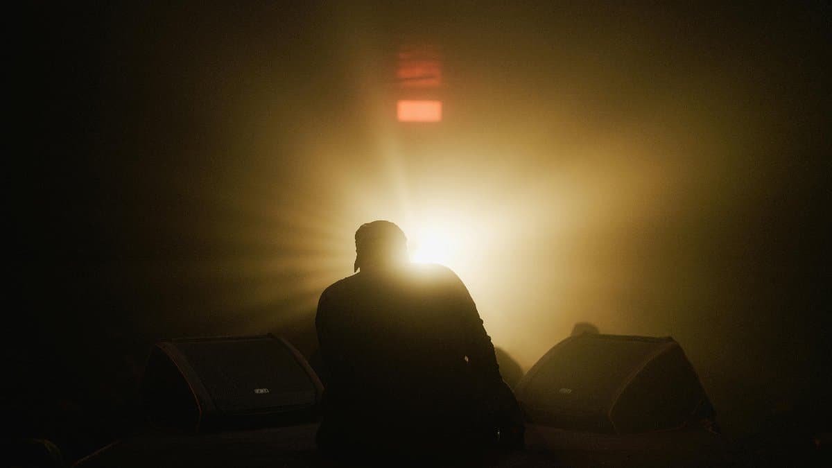 Silhouette of a performer on stage with dramatic backlighting, conveying a sense of mystery and intrigue. via Pexels