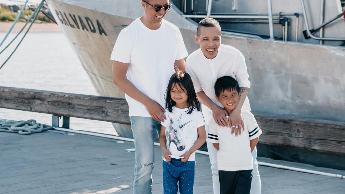 Joyful family enjoying quality time together on a sunny day by the pier. via Pexels