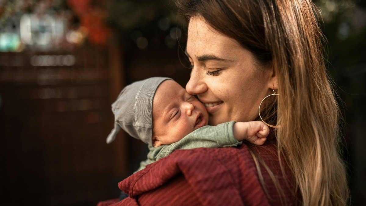 A warm embrace between a mother and her sleeping newborn baby outdoors. via Pexels