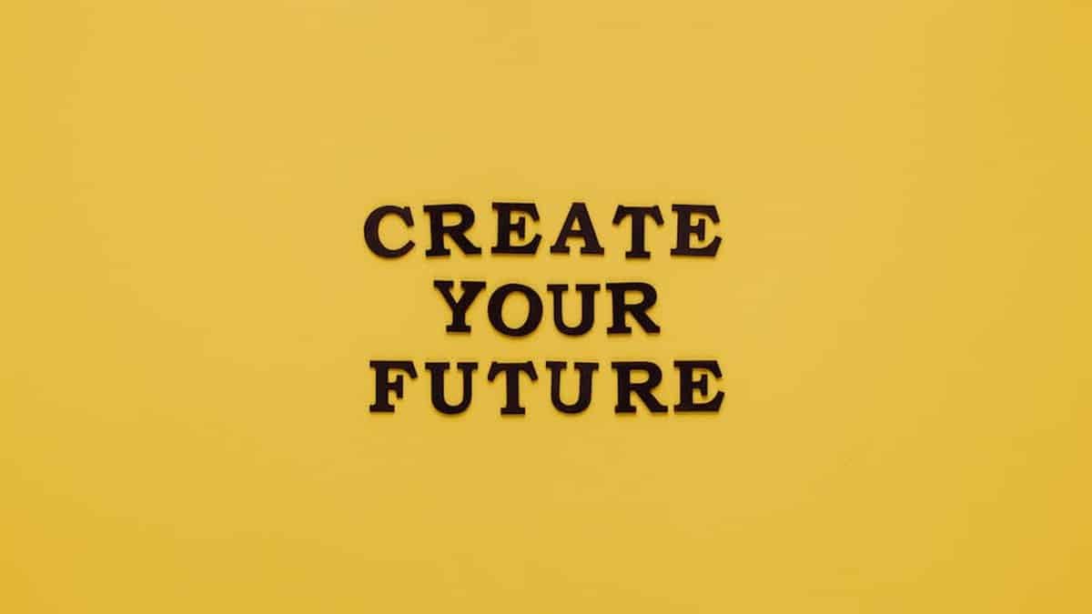 Bold text 'CREATE YOUR FUTURE' on minimalist yellow background. Inspiring design. via Pexels