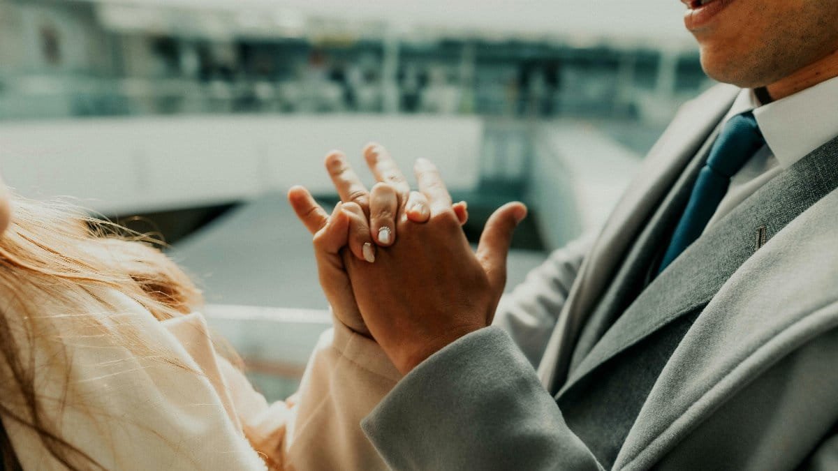 A touching moment of a couple holding hands, symbolizing love and unity at a wedding in Buenos Aires. via Pexels