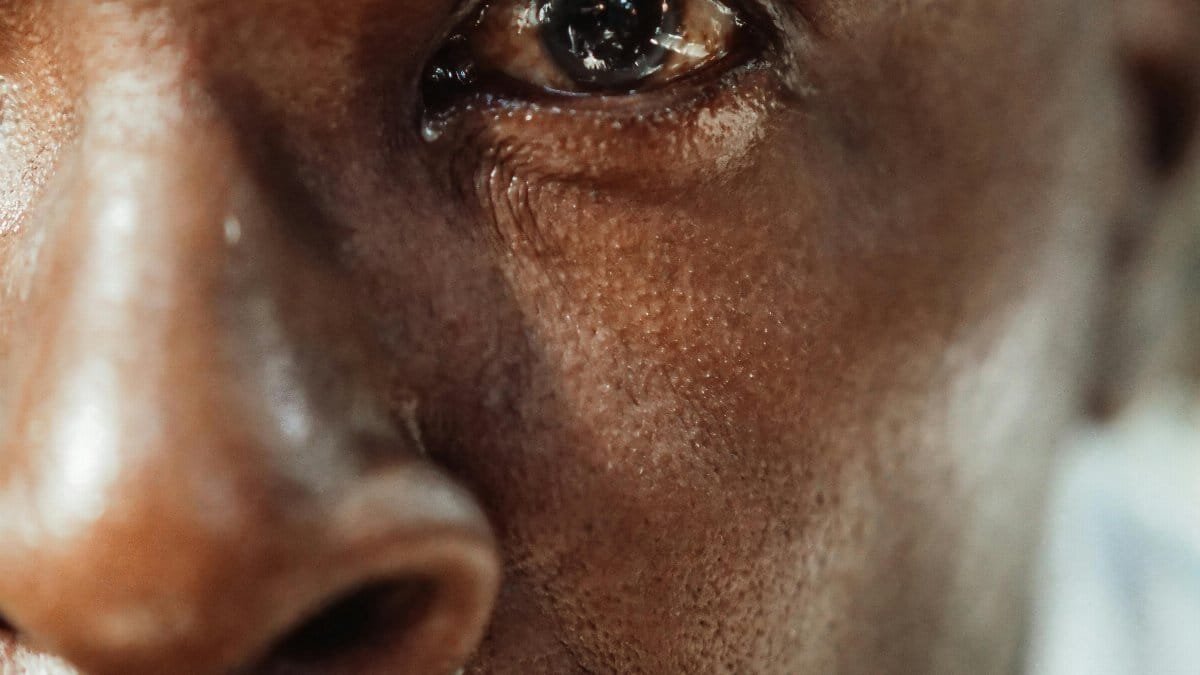 A close-up of an elderly man's face showing deep emotion and reflection. via Pexels