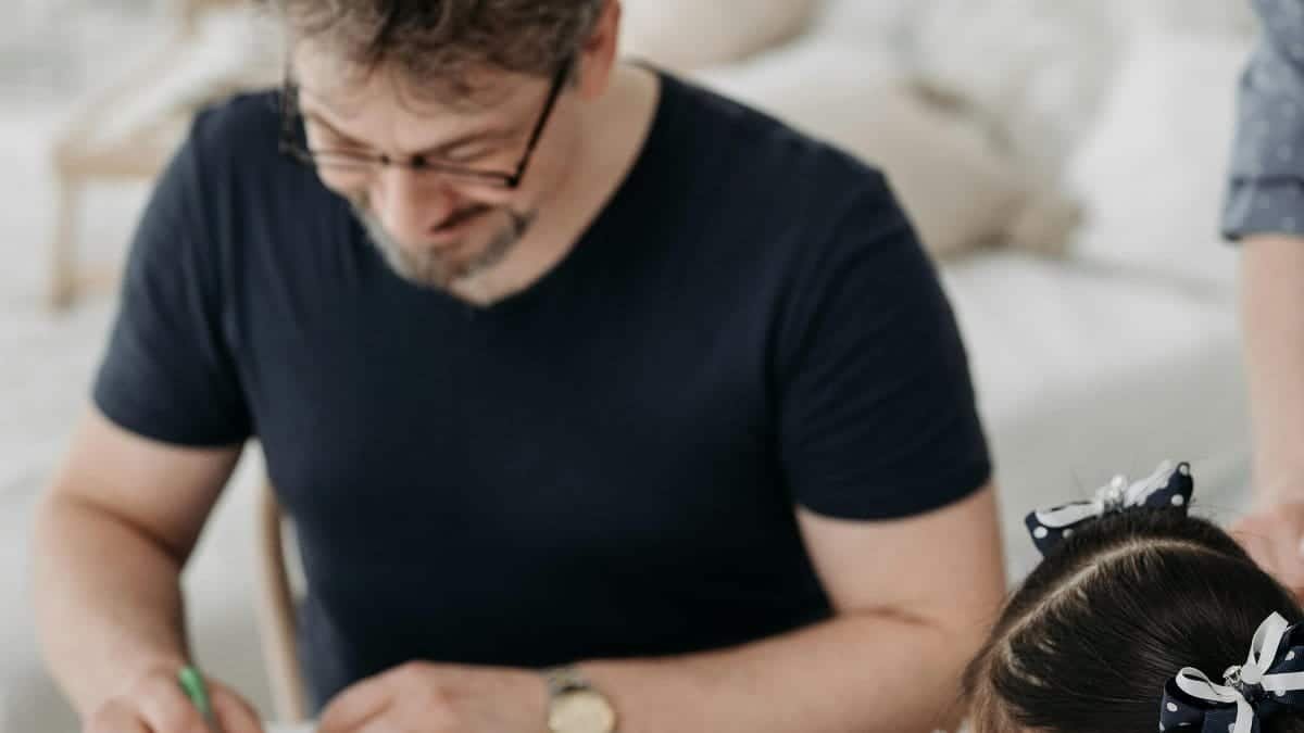 Father and daughter enjoying creative drawing together at home with colored pens and paper. via Pexels