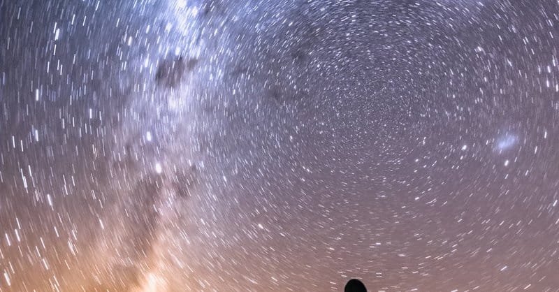 A person gazes at the Milky Way in a stunning star-filled night sky landscape. via Pexels