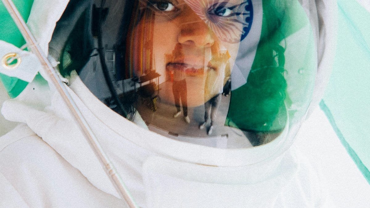 Portrait of an Indian woman in a space suit, reflecting India&#039;s space achievements. Flag theme visible. via Pexels