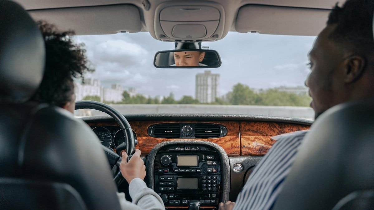 Father and son bonding while driving, showcasing guidance and togetherness in a car&#039;s interior. via Pexels