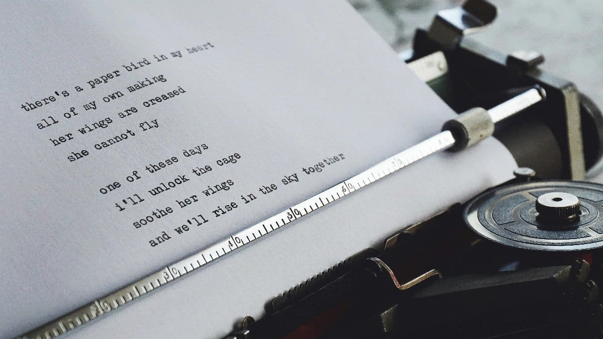 Close-up of a vintage typewriter printing a heartfelt poem on paper. via Pexels