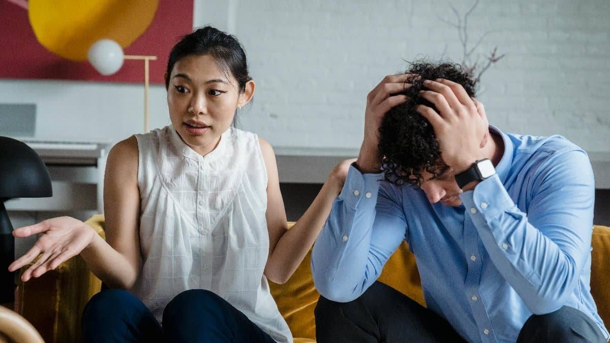 A couple having a serious conversation indoors, expressing emotions and misunderstanding. via Pexels