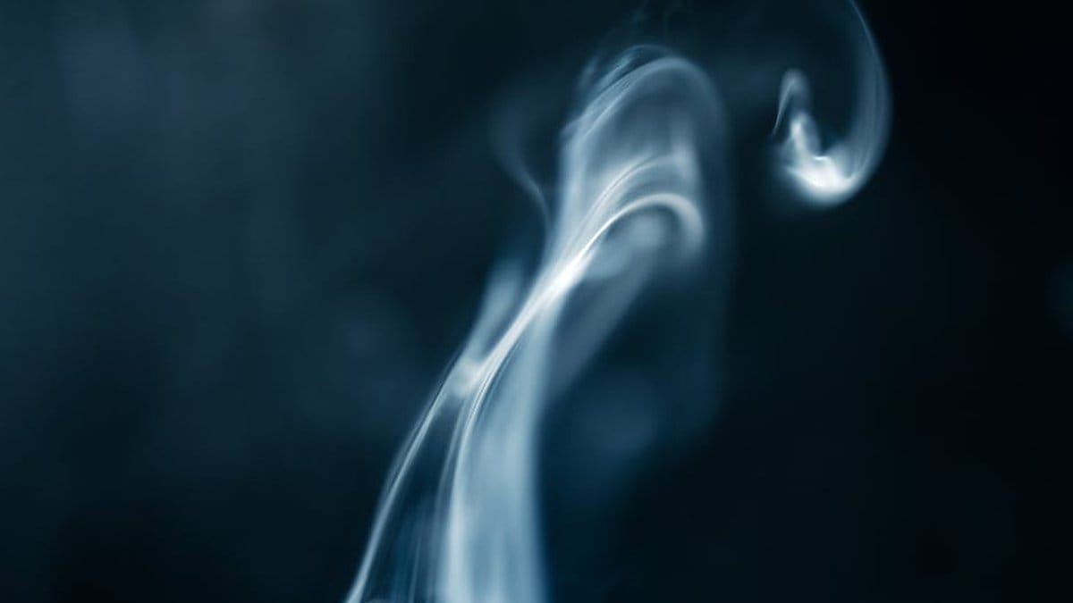 A captivating abstract image of swirling smoke against a dark background. via Pexels