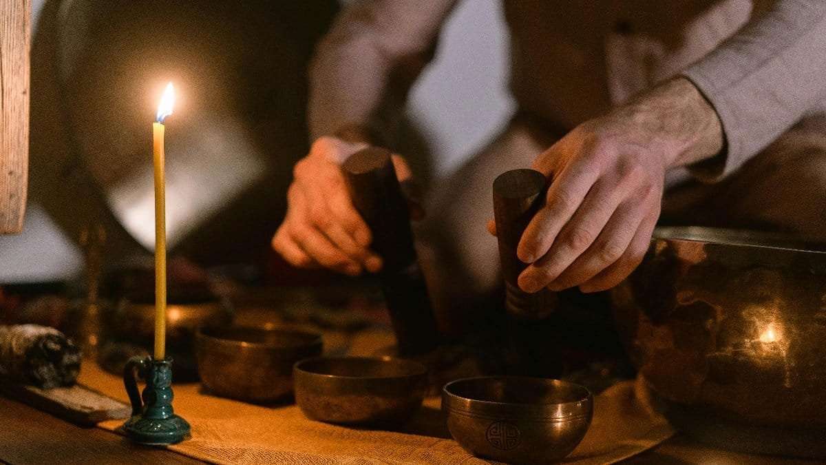 A serene meditation setting with singing bowls and candlelight, emphasizing mindfulness and tranquility. via Pexels