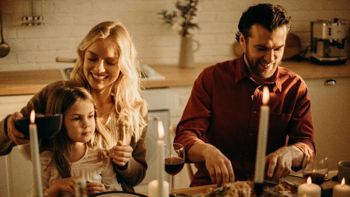 Family enjoying a cozy holiday dinner together, sharing love and joy indoors. via Pexels