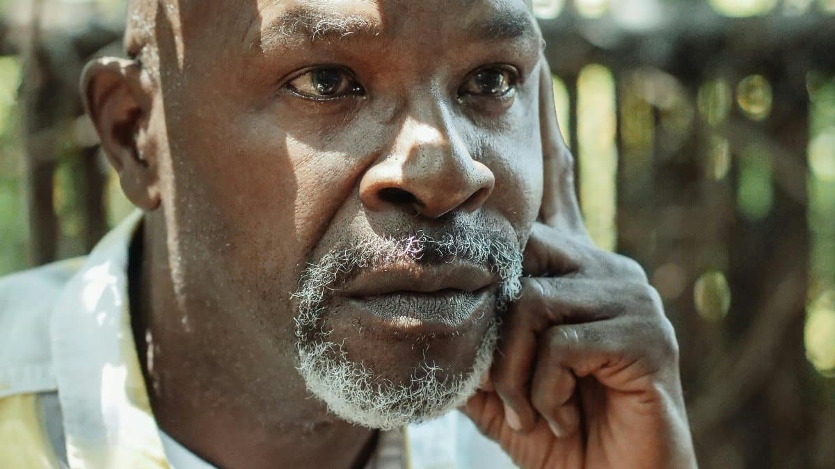 Thoughtful senior man in an outdoor setting, expressing deep emotions. via Pexels