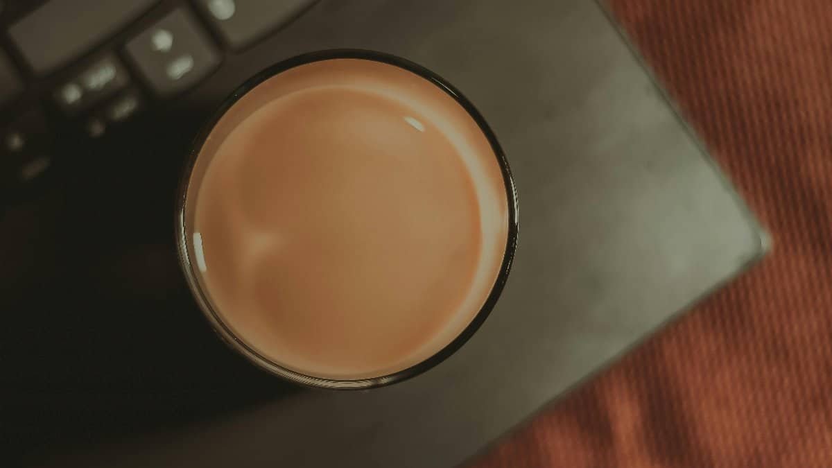 Top view of coffee cup on laptop, minimalist and serene workspace in Aracati, Brazil. via Pexels
