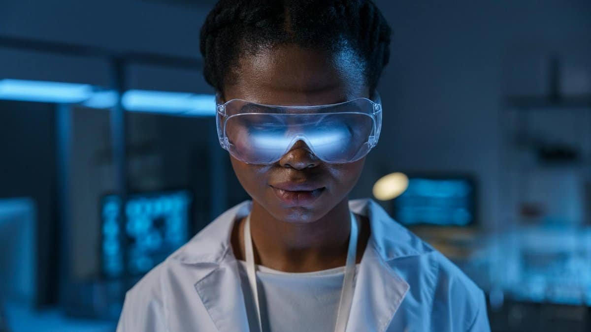 Portrait of a scientist in protective eyewear working in a modern laboratory setting.