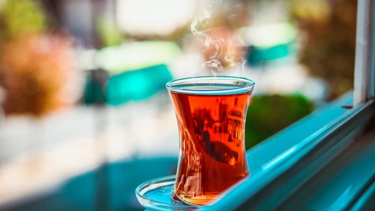 A steaming cup of Turkish tea on a windowsill with blurred background in Gaziantep.