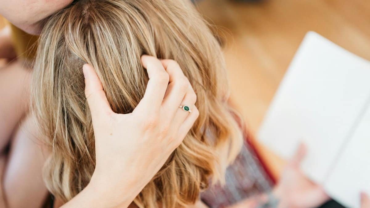 Tender moment between a couple captured with a gentle embrace and a focus on a ring.
