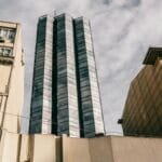Low-angle shot of a modern skyscraper amidst historic architecture in Istanbul, Turkey.