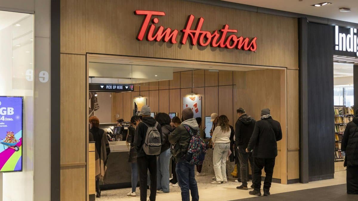 Busy Tim Hortons with customers waiting in line at the counter.