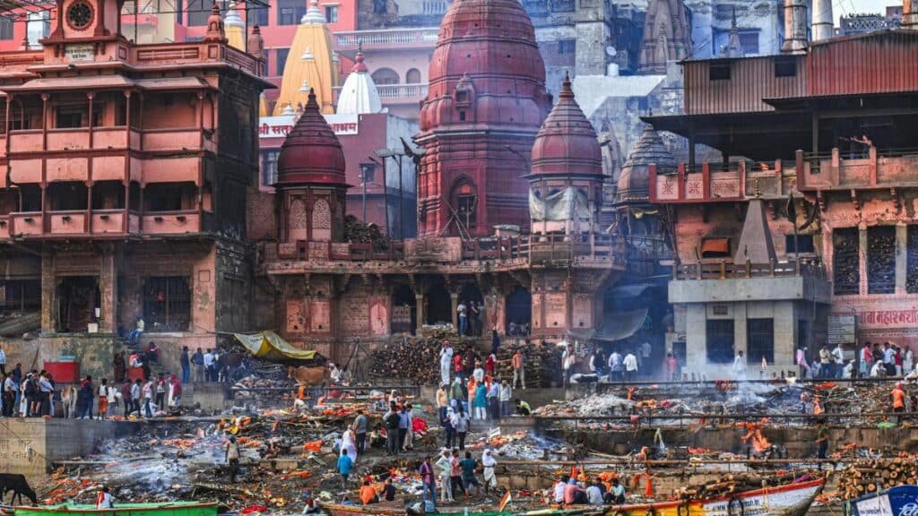 A vibrant scene of rituals at Manikarnika Ghat in Varanasi, showcasing traditional Hindu customs along the Ganges River.