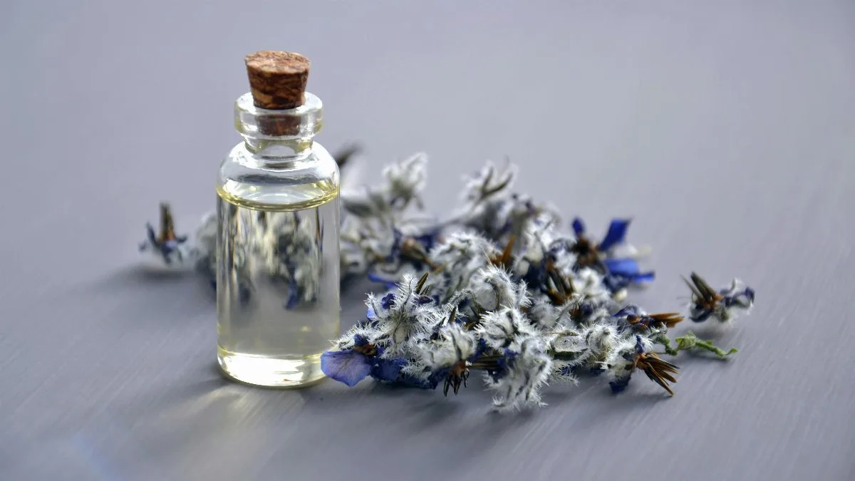 Close-up of a lavender oil bottle with dried flowers for aromatherapy. Perfect for wellness themes.