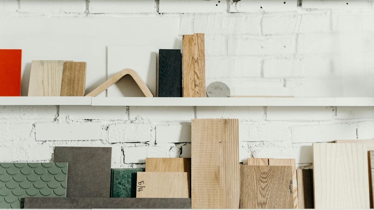 Close-up of shelves showcasing various wooden planks and materials in a workshop environment.