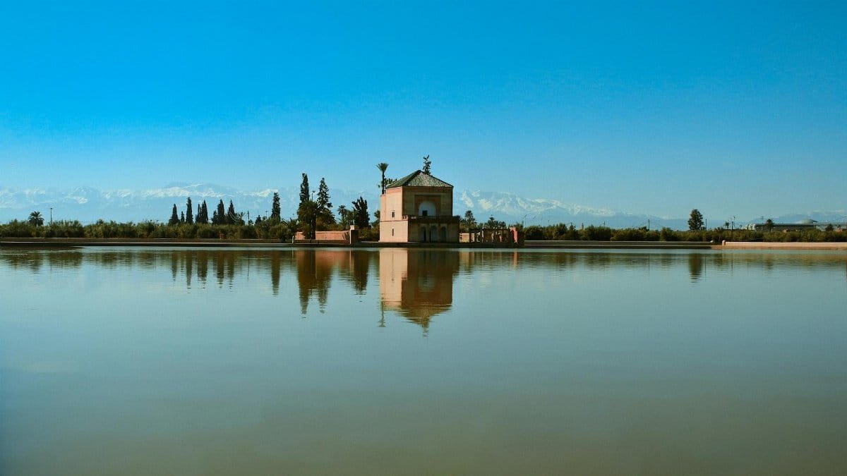 Scenic view of the Menara Gardens pavilion with water reflections in Marrakesh, Morocco.