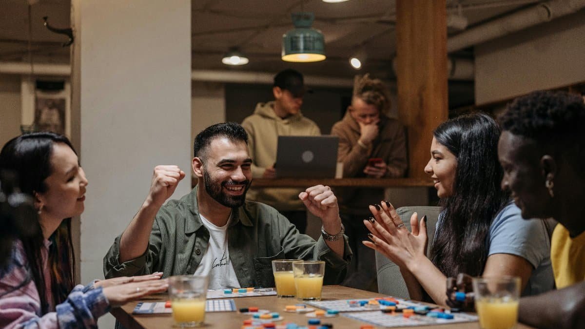 A group of friends playing a board game indoors, enjoying fun and laughter.