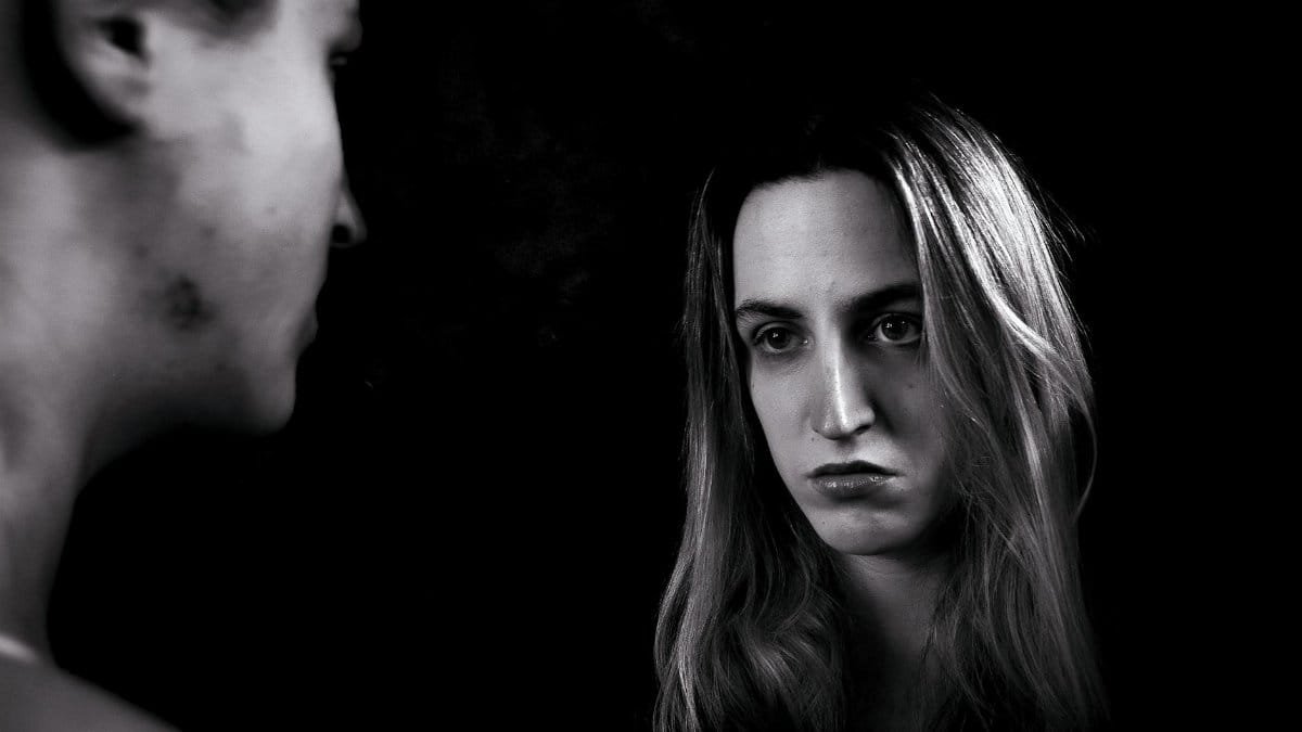 Artistic black and white portrait capturing a thoughtful reflection.
