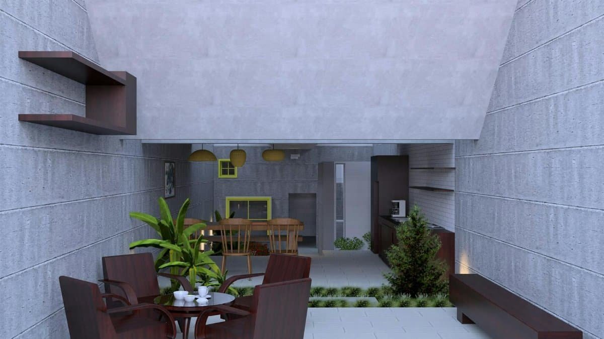 A modern minimalist indoor patio featuring stylish furniture and greenery.