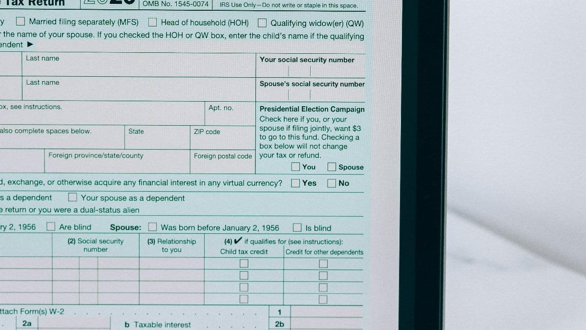 Laptop showing tax form with a reminder note, emphasizing tax payment.