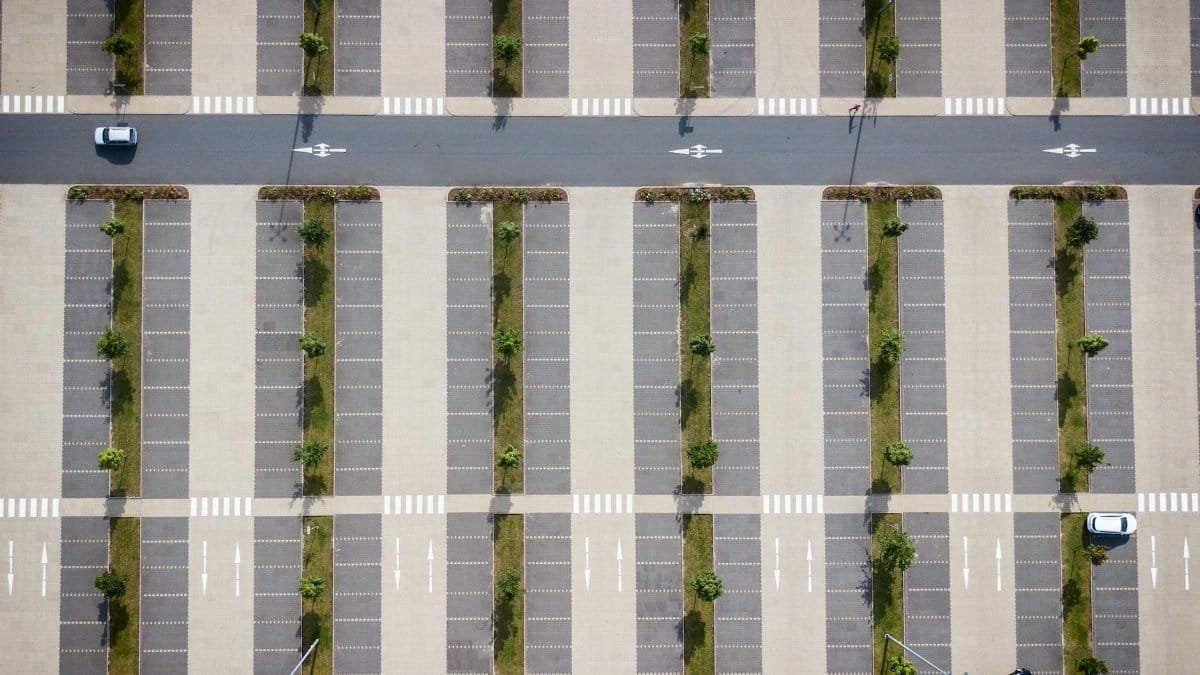 Drone shot showcasing the geometric pattern of an empty parking lot in Soltau, Germany.