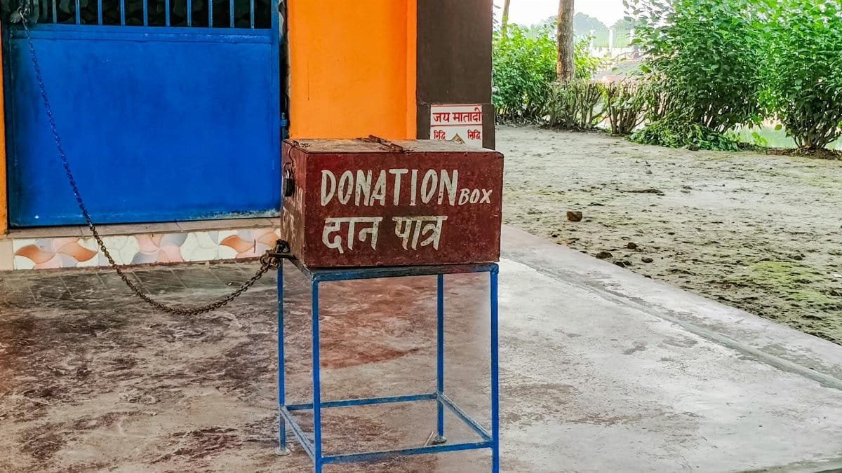 Donation box outside an Indian temple, symbolizing charity and spirituality.
