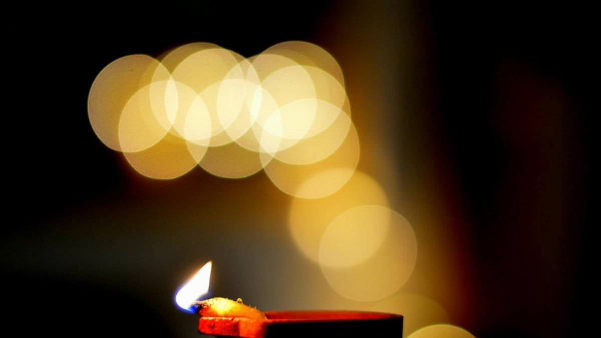 A candle flame with a beautiful bokeh effect, creating a warm and serene atmosphere.