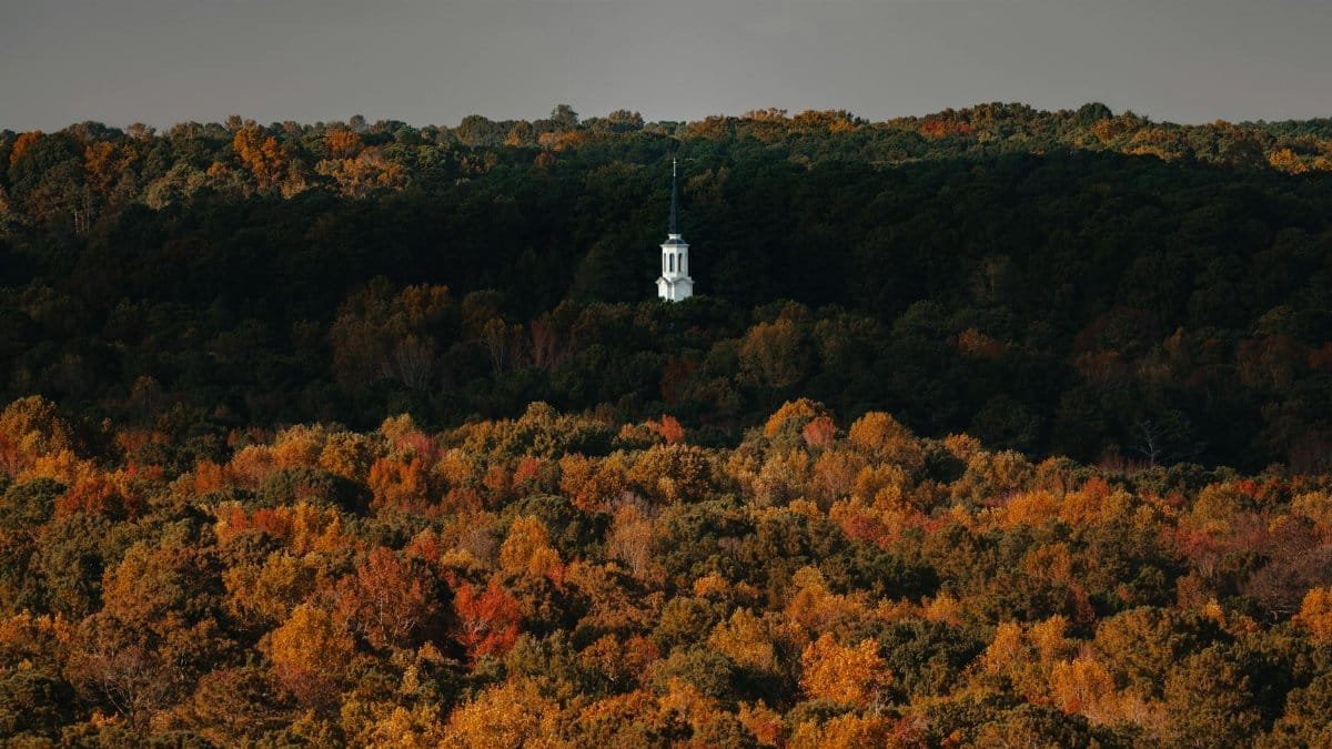 A bell tower surrounded by vibrant autumn foliage in Stone Mountain, Georgia.