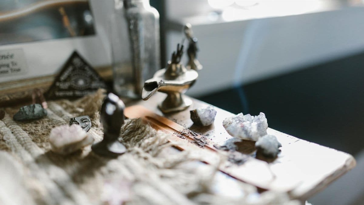 An enchanting arrangement featuring crystals and incense on a wooden surface, evoking tranquility and spirituality.