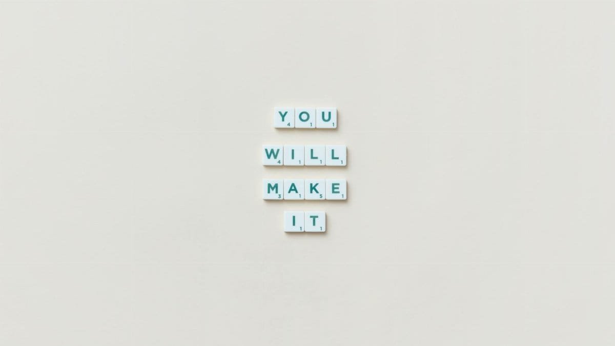 Motivational phrase 'You Will Make It' made from Scrabble tiles on a neutral background.