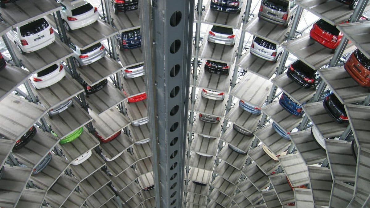 A vertical view of a spiral multi-storey car park filled with vehicles.