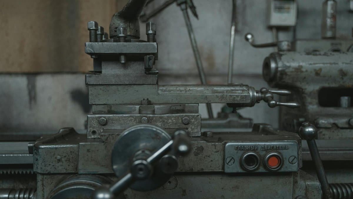 Close-up of an antique lathe showcasing tools and machinery in a vintage workshop.