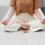 A person meditating outdoors with a singing bowl, embracing serenity and mindfulness.