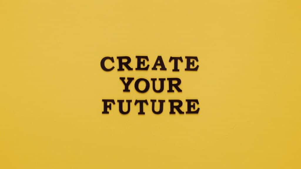 Bold text 'CREATE YOUR FUTURE' on minimalist yellow background. Inspiring design.