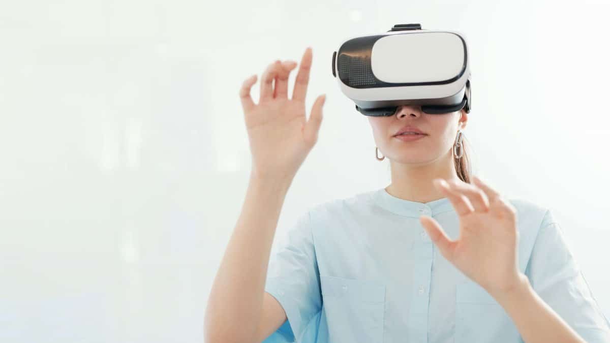 Young woman exploring the virtual world using a VR headset indoors, feeling the future of technology.