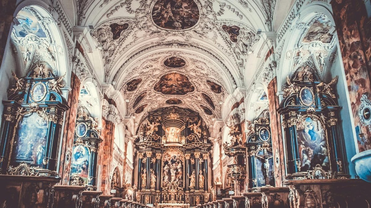 Explore the intricate, ornate baroque architecture inside a historic church, showcasing religious art and spirituality.