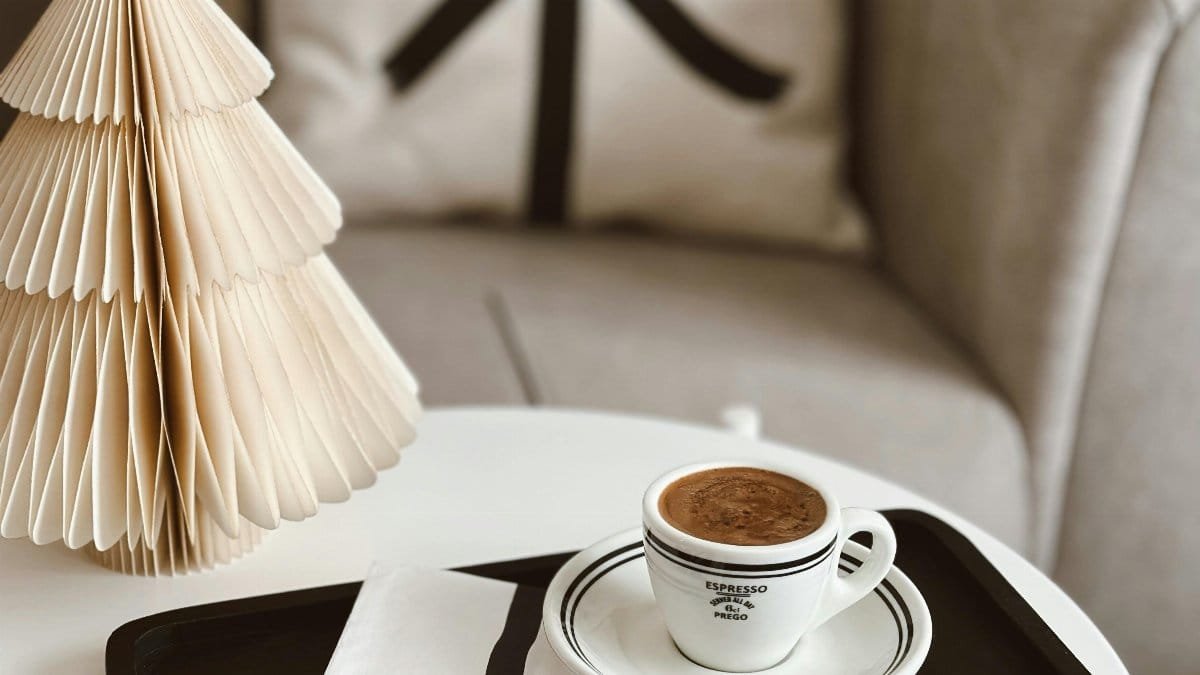 A warm, inviting coffee setup with festive decor, ideal for winter holidays.