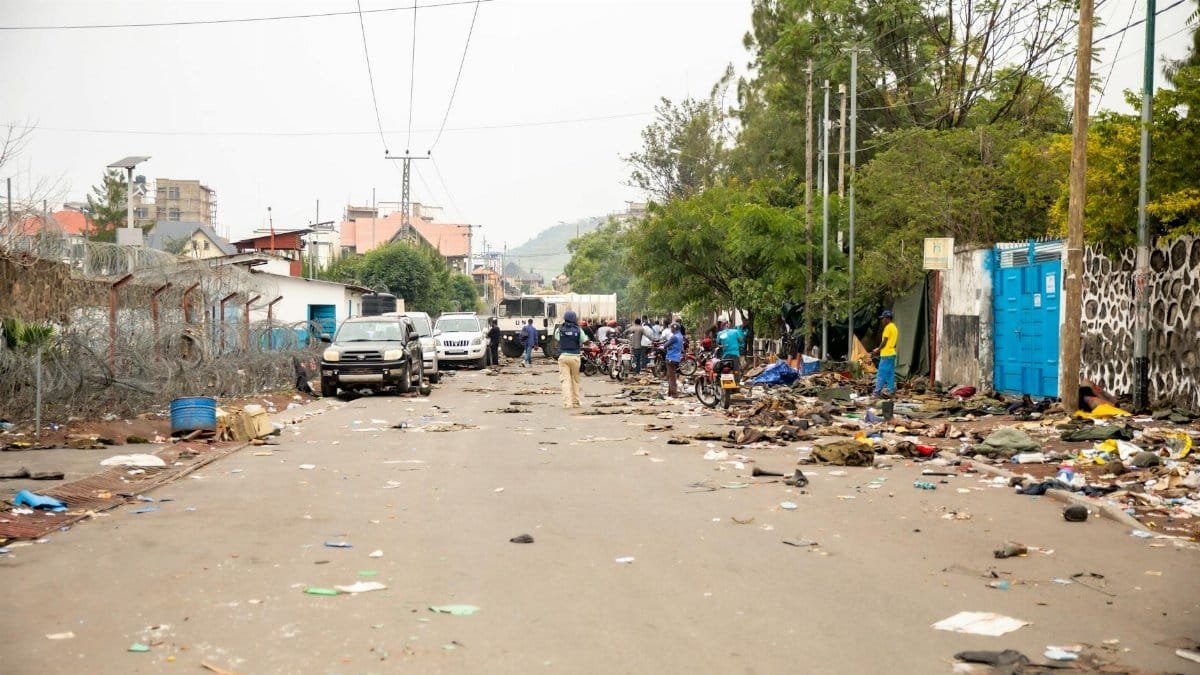 Busy urban road with litter and debris, showcasing city life and community challenges.