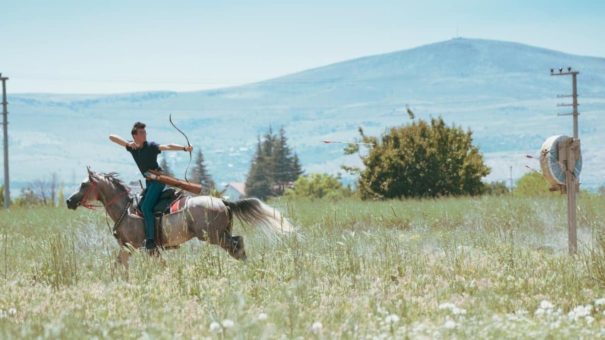 A skilled archer rides horseback in Konya's fields, capturing tradition.