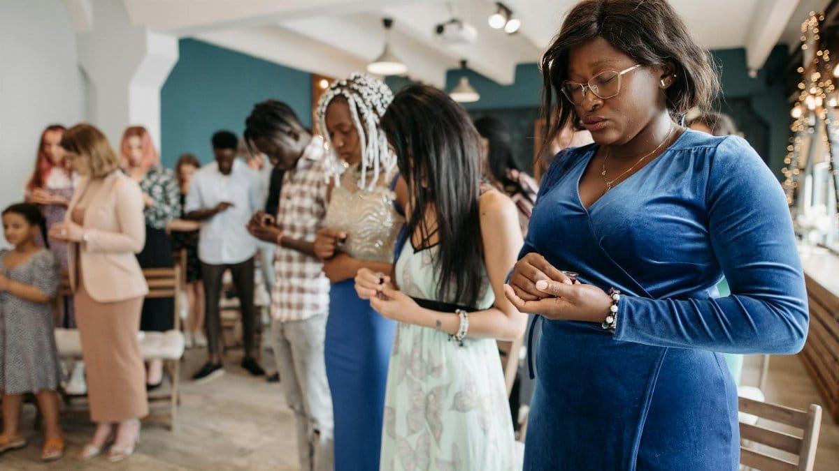 A diverse congregation praying together in a serene indoor environment representing unity and faith.