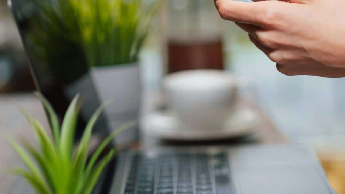 reading content on smartphone home table laptop