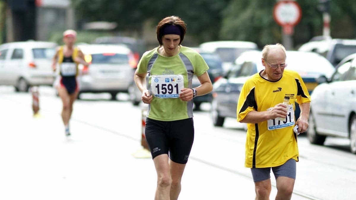 Adult and senior runners participating in an urban marathon race, showcasing endurance and fitness.